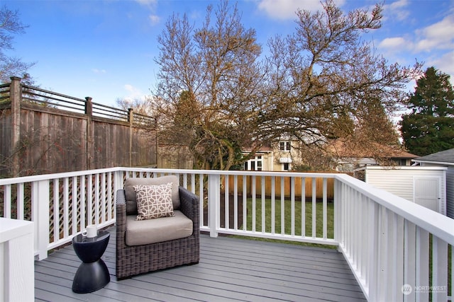 wooden terrace featuring a yard