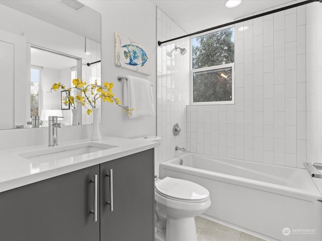 full bathroom with vanity, tiled shower / bath, tile patterned flooring, and toilet