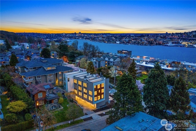 aerial view at dusk with a water view