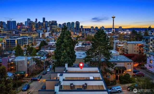 aerial view at dusk featuring a view of city