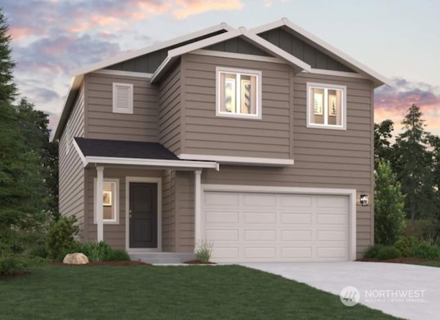 view of front of home featuring a garage and a lawn