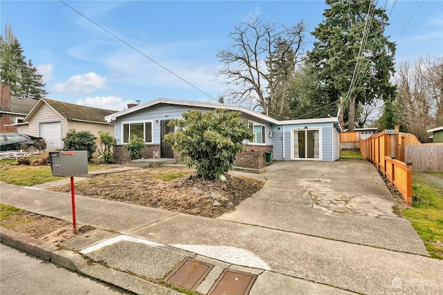 view of front of property featuring fence and brick siding