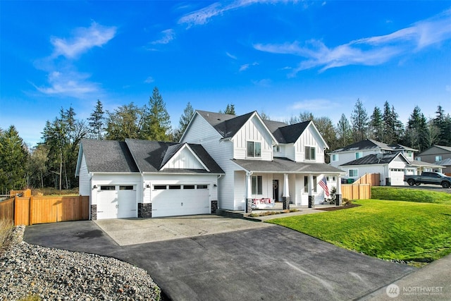 view of front facade featuring a garage, a front lawn, and a porch