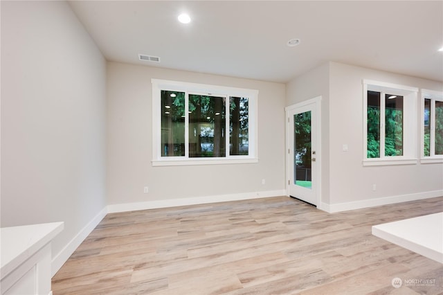 spare room with light hardwood / wood-style floors