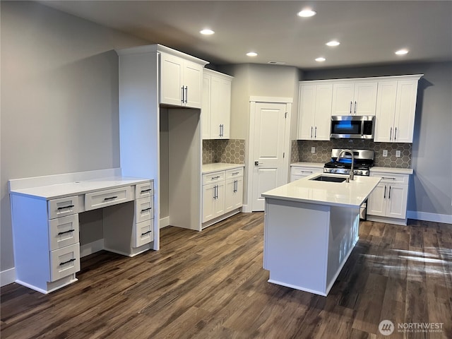 kitchen with appliances with stainless steel finishes, sink, and white cabinets