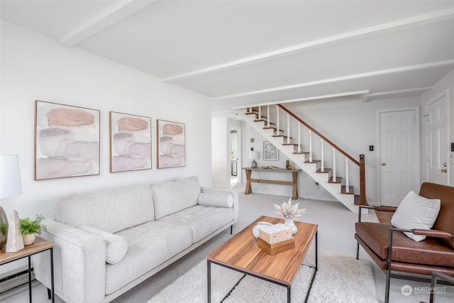 carpeted living room with beamed ceiling