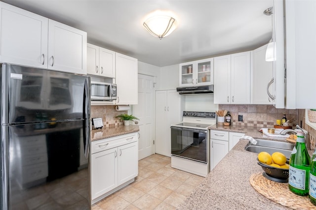 kitchen featuring sink, black refrigerator, white cabinetry, electric range, and decorative backsplash