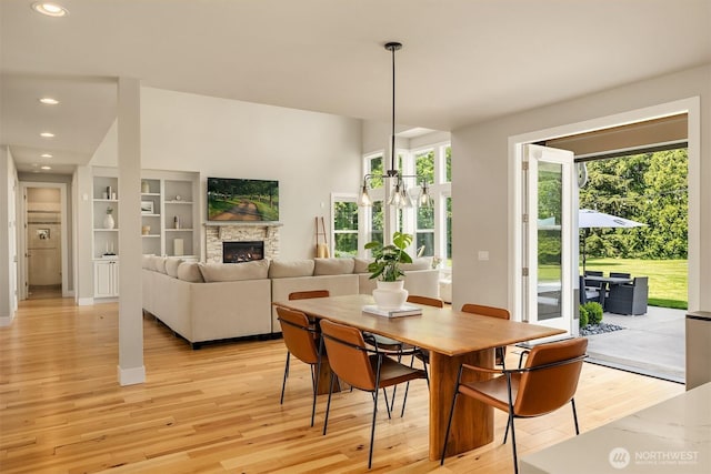 dining area featuring a wealth of natural light, a fireplace, light wood-style flooring, and recessed lighting