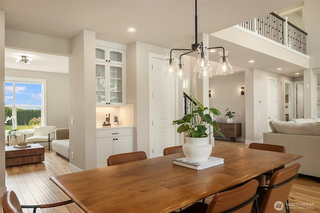 dining area with stairs, recessed lighting, and light wood-style floors