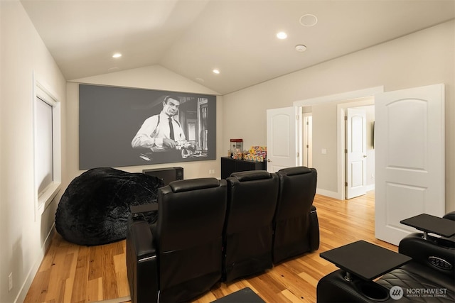 cinema featuring lofted ceiling, light wood finished floors, baseboards, and recessed lighting