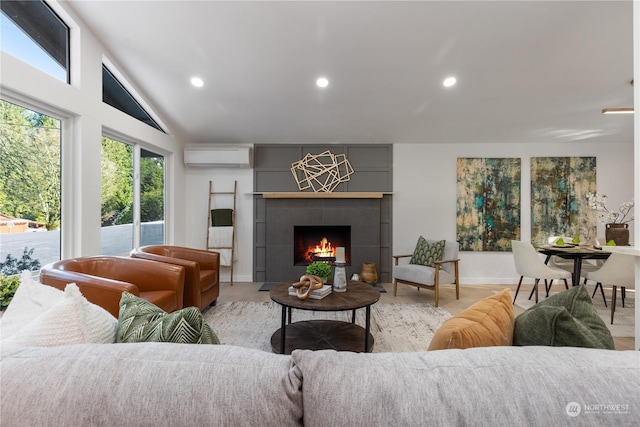 living room with light hardwood / wood-style flooring, a wall mounted air conditioner, a fireplace, and lofted ceiling