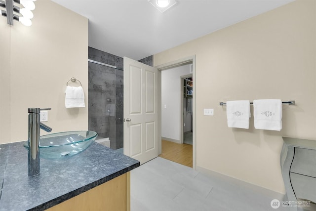 300 110th Ave NE # 611, Bellevue, WA 98004 - full bathroom featuring tiled shower, vanity, and baseboards
