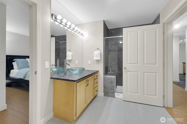 300 110th Ave NE # 611, Bellevue, WA 98004 - bathroom with a tile shower, connected bathroom, vanity, and wood finished floors