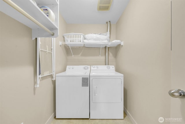 300 110th Ave NE # 611, Bellevue, WA 98004 - laundry area with baseboards, washing machine and dryer, and laundry area