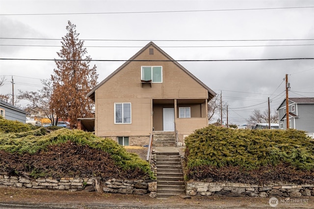 bungalow-style house featuring stairs