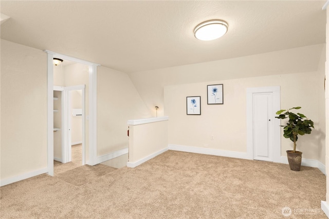 bonus room with vaulted ceiling, carpet, and baseboards