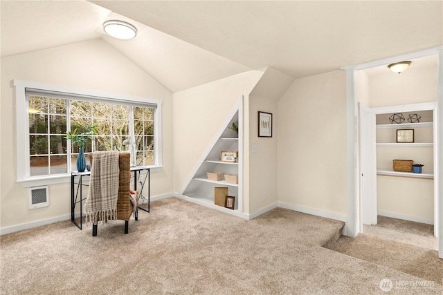 sitting room featuring stairway, built in shelves, lofted ceiling, and carpet floors