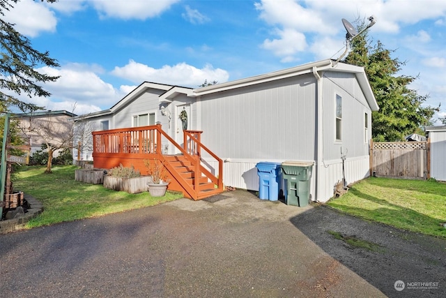 rear view of property with a lawn