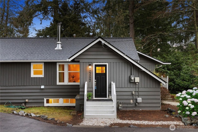 view of front of house featuring a shingled roof and board and batten siding