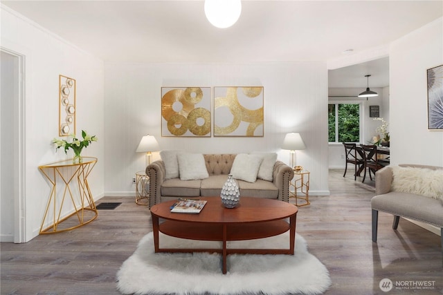 living room with baseboards and wood finished floors