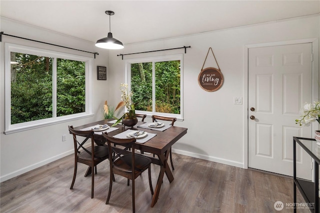 dining area featuring wood finished floors and baseboards