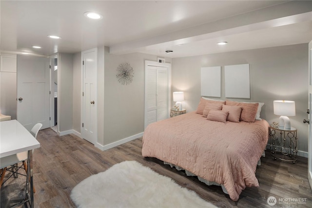 bedroom featuring dark wood-type flooring, recessed lighting, a closet, and baseboards