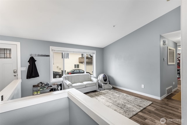 bedroom with lofted ceiling, baseboards, visible vents, and dark wood finished floors