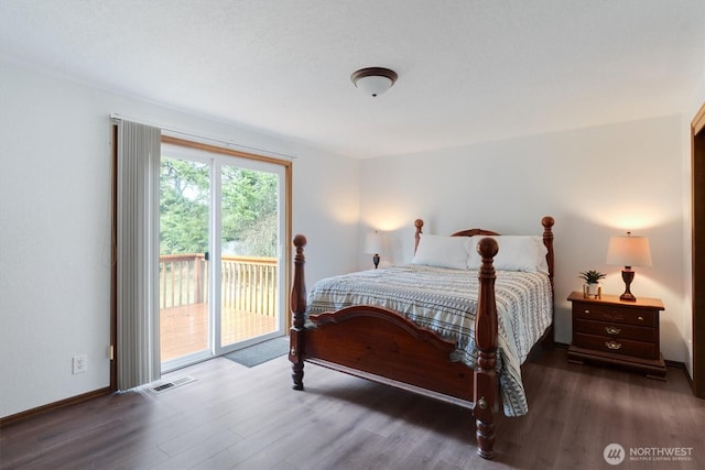 bedroom featuring access to exterior and dark hardwood / wood-style floors