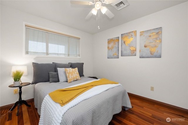 bedroom with dark hardwood / wood-style flooring and ceiling fan