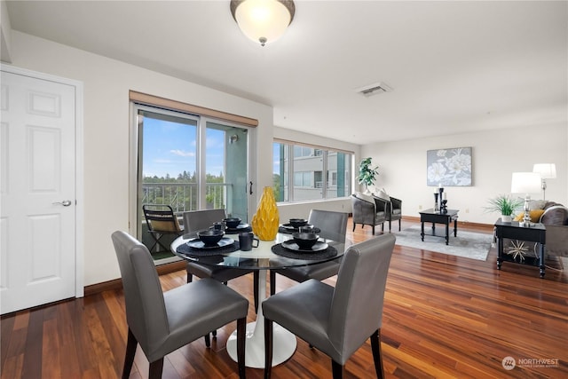 dining room with dark hardwood / wood-style flooring