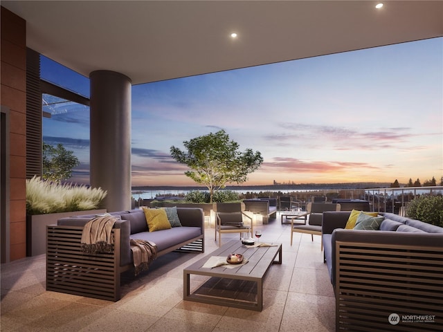 patio terrace at dusk featuring an outdoor hangout area and a water view