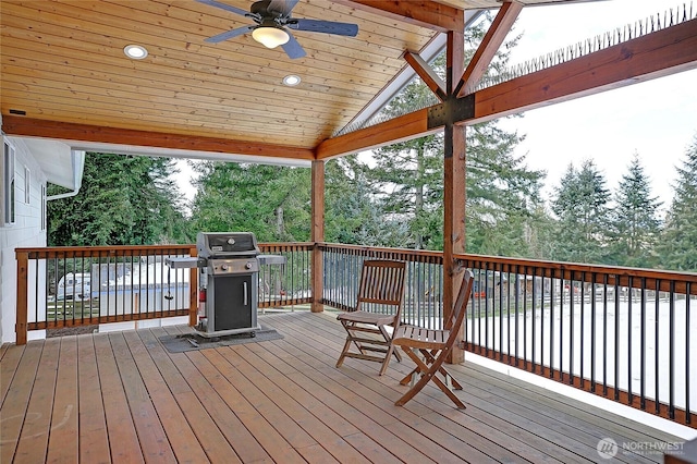 deck featuring area for grilling and ceiling fan