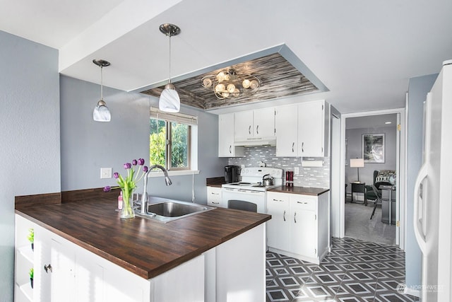 kitchen featuring sink, white appliances, hanging light fixtures, white cabinets, and wood counters