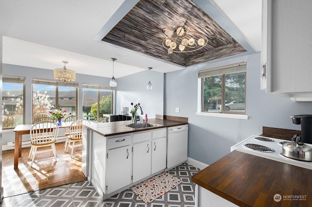 kitchen with white cabinetry, sink, hanging light fixtures, white dishwasher, and kitchen peninsula