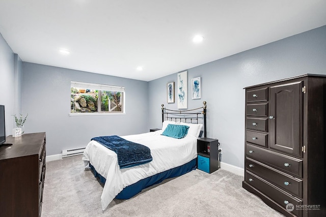 bedroom with light carpet and a baseboard heating unit