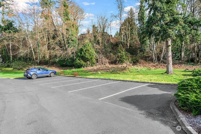 view of parking featuring a lawn