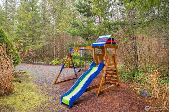 view of play area featuring a wooded view