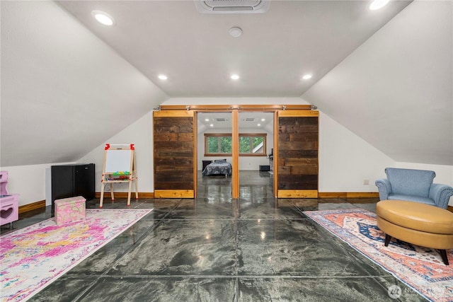 interior space featuring lofted ceiling, visible vents, and baseboards