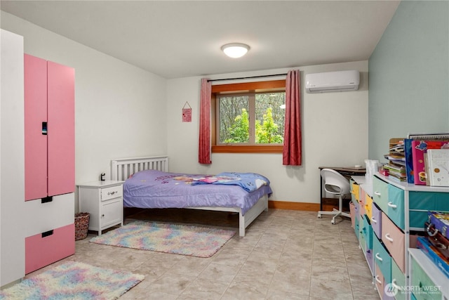 bedroom with baseboards and a wall mounted AC