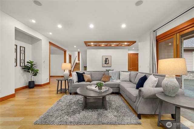 living room with baseboards, stairway, light wood-style flooring, and recessed lighting