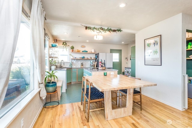 dining room with sink and light hardwood / wood-style floors