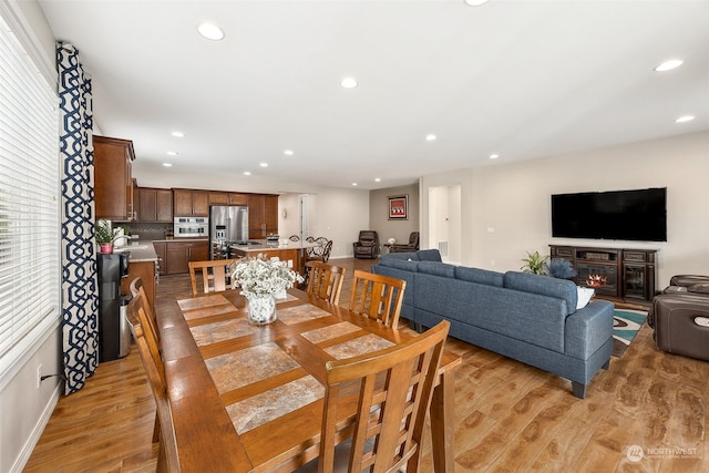 dining space with light hardwood / wood-style flooring and sink