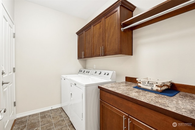 clothes washing area with cabinets and washing machine and clothes dryer