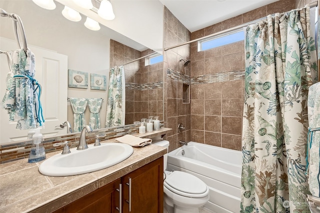 full bathroom with shower / bath combo with shower curtain, vanity, and toilet