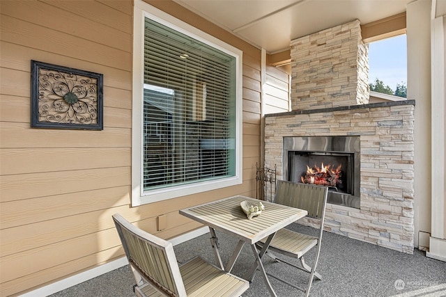 view of patio / terrace featuring an outdoor stone fireplace