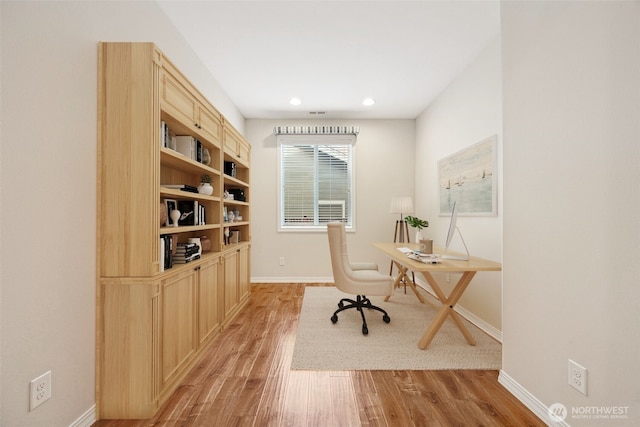 office with light hardwood / wood-style floors