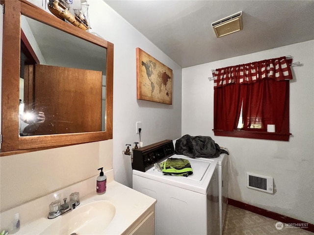 washroom featuring washing machine and clothes dryer and sink