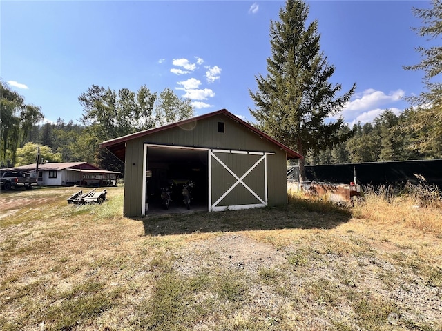 view of outbuilding featuring a yard