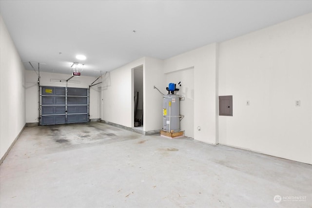 garage featuring a garage door opener, strapped water heater, and electric panel