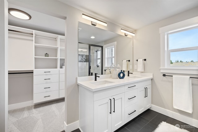 bathroom with tile patterned flooring, vanity, and a shower with shower door